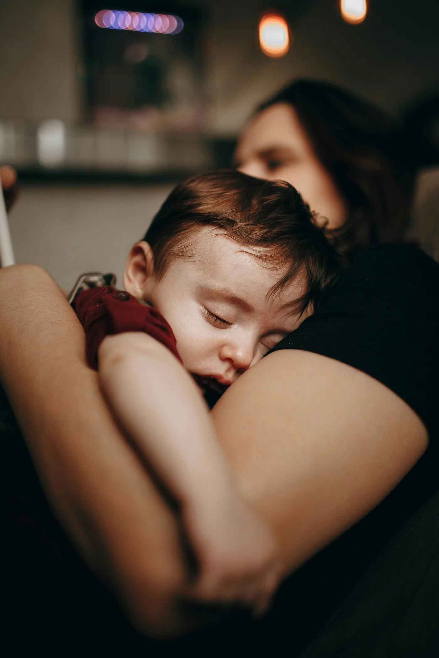 Parent holding a calm baby while using PediaPulse for pediatric guidance